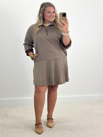 Brown gingham half-zip dress with long sleeves and swing skirt hem