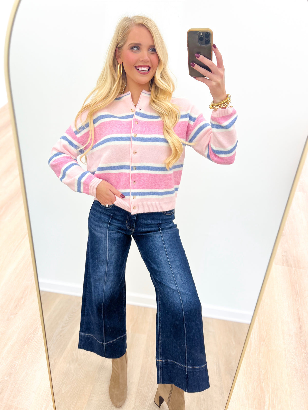 Pink multi-striped long sleeve cardigan with button front and ribbed cuffs, soft knit.