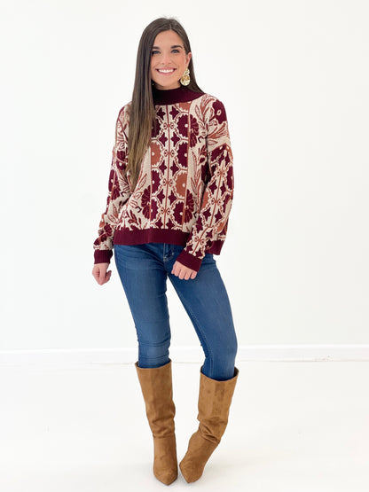 Wine knit sweater with ornate floral tapestry print, crew neck, ribbed cuffs and hem