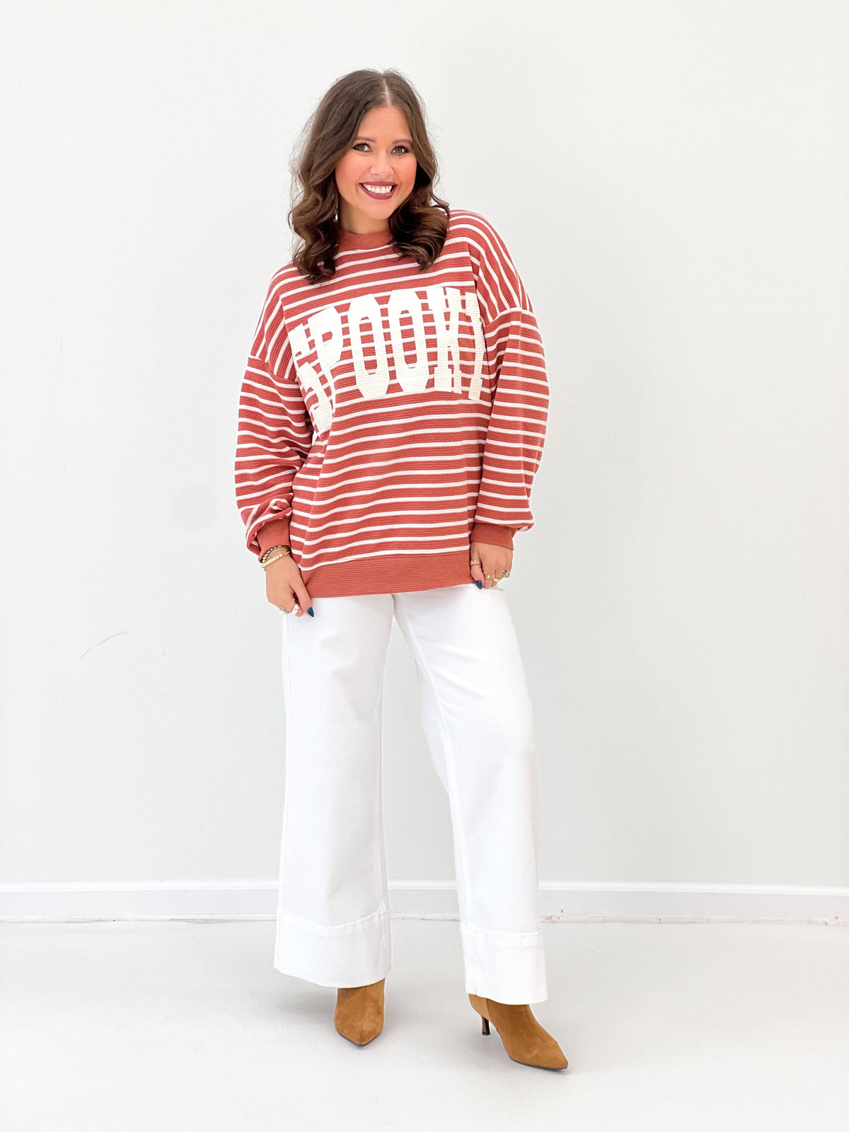 Rust red and white striped knit top with spooky graphic, loose fit