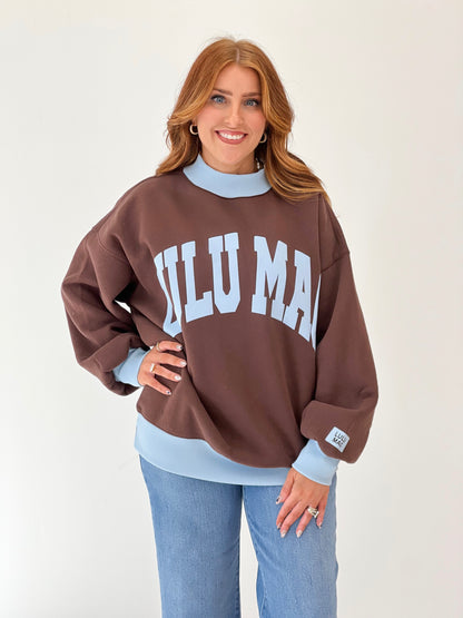 LuLu Mac brown puff mock neck sweatshirt with white “LULU MAC” graphic and light blue collar