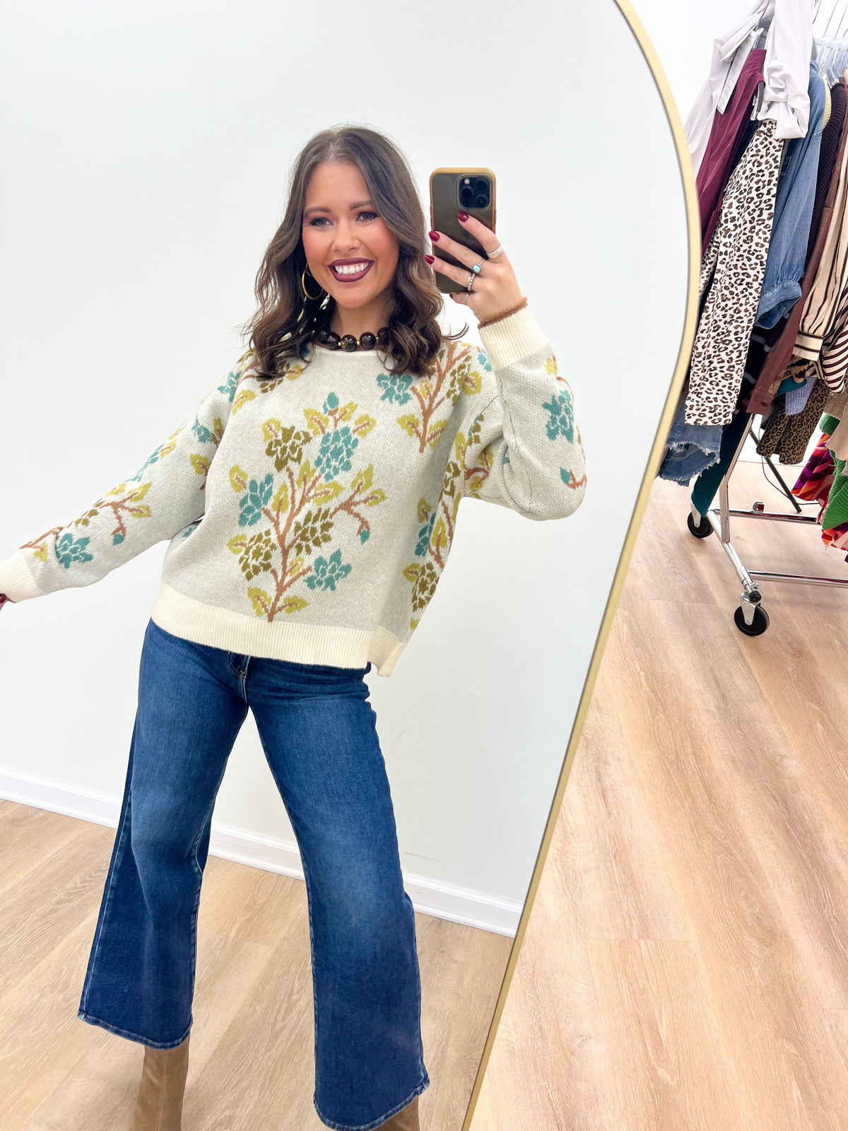 Cream knit sweater top with tree print, long sleeves, crew neck, ribbed cuffs and hem