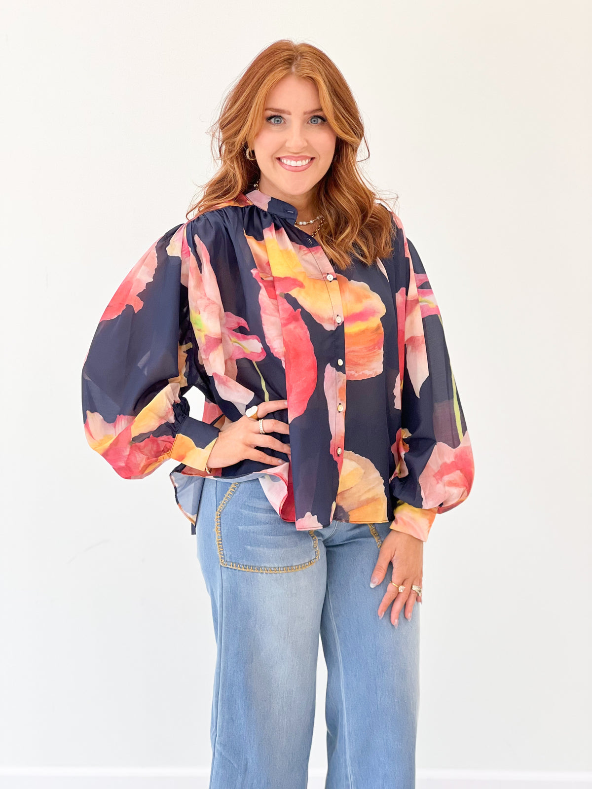 Navy floral print blouse with loose shoulders, button front and billowy sleeves