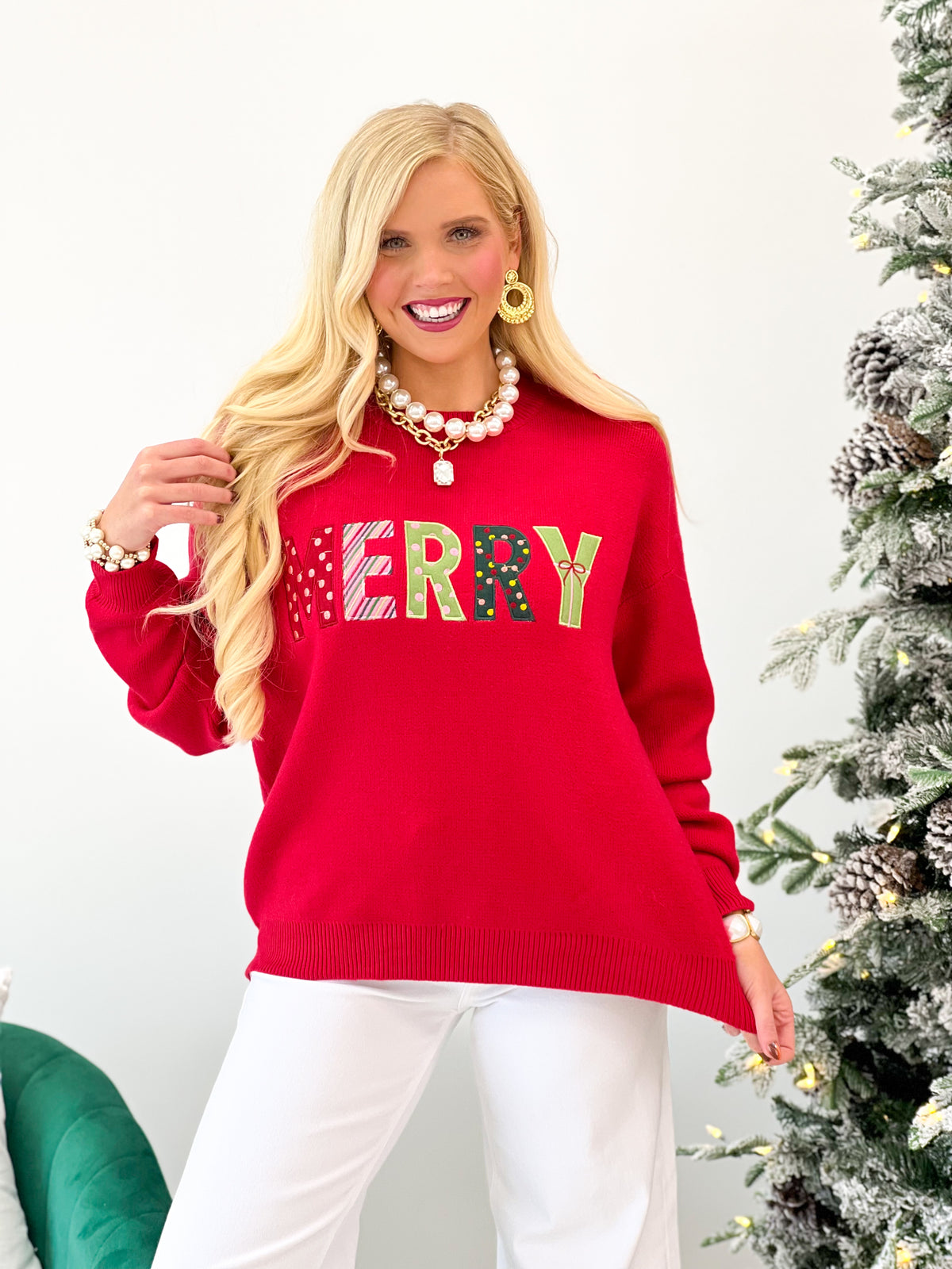 Red knit Christmas sweater with colorful “MERRY” letter graphic and ribbed hem