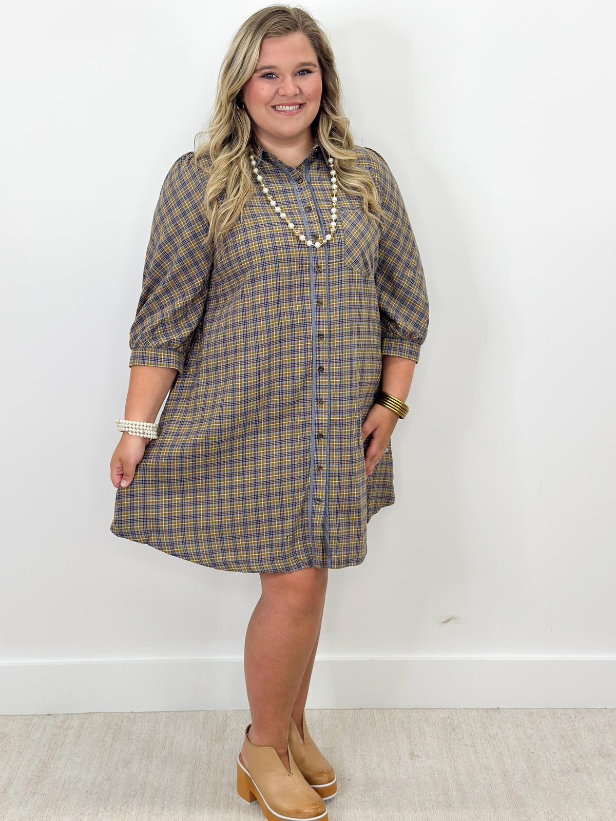 Blue plaid button-down long-sleeve dress with collar and front buttons, above-knee length