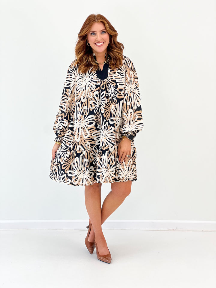 Black abstract floral print ruffle hem dress with gathered long sleeves and V neckline