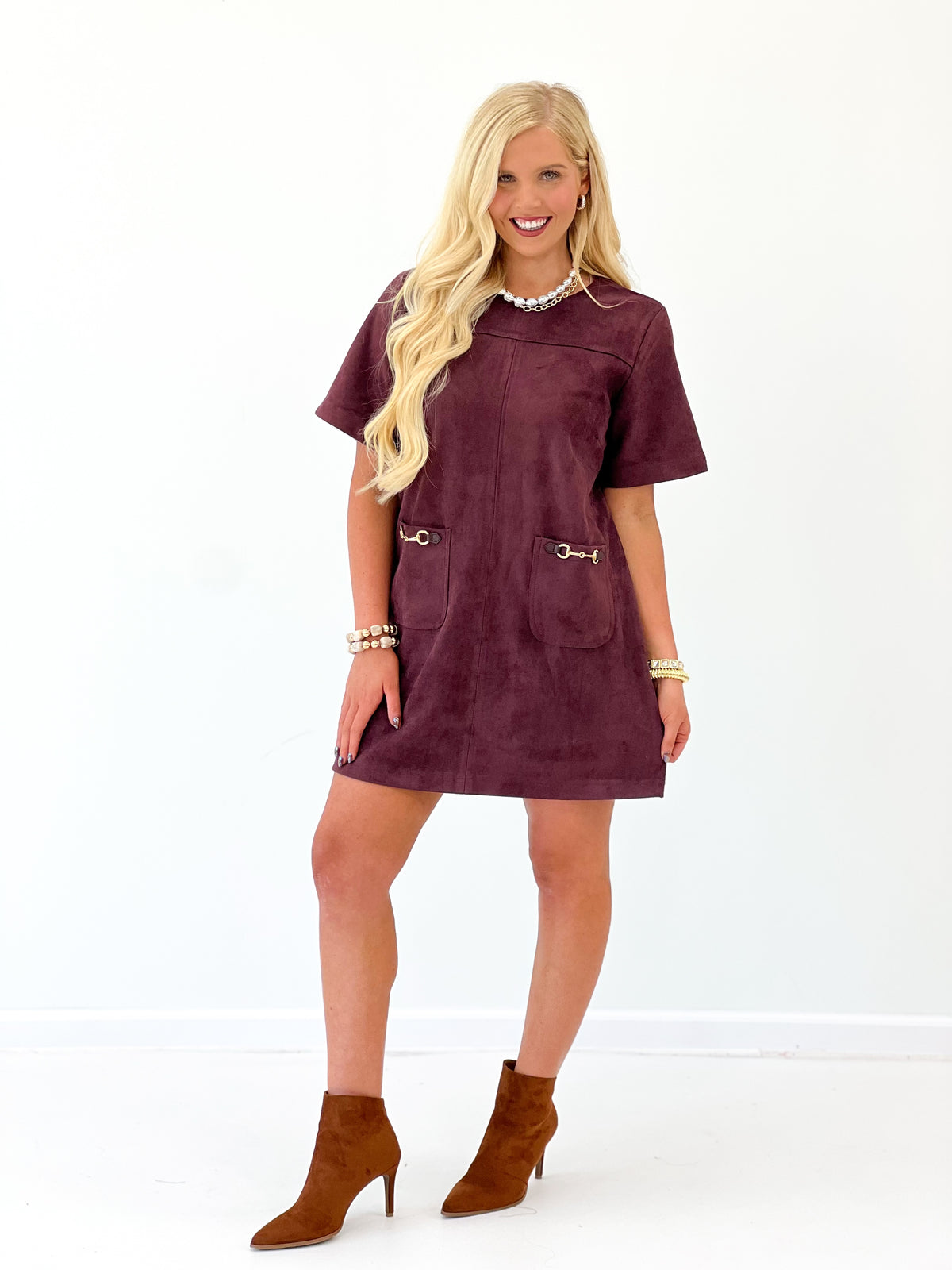 Merlot suede mini dress with short sleeves and two front pockets with hardware tabs