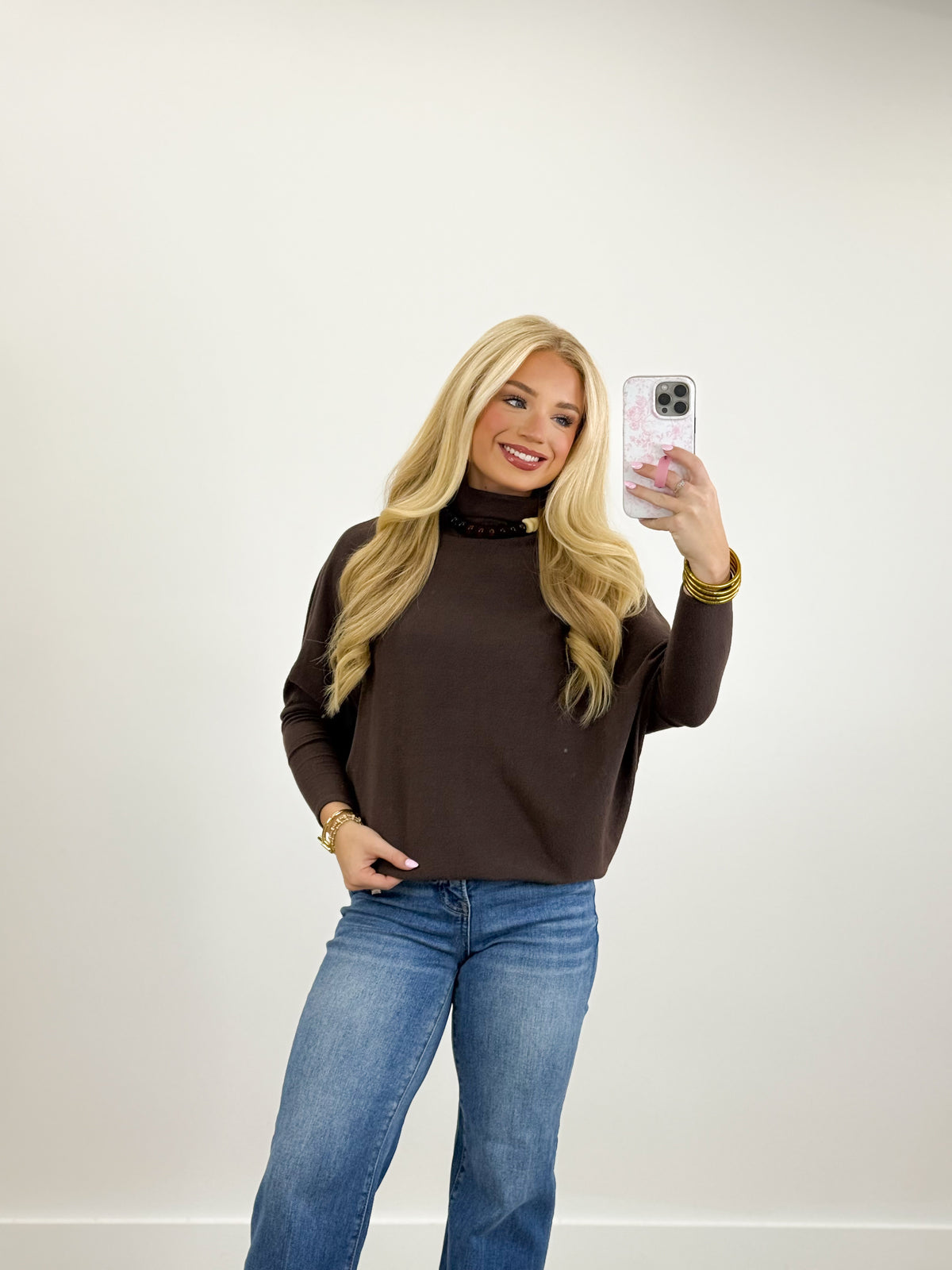 Dark brown mockneck dolman top with long sleeves and loose swing silhouette