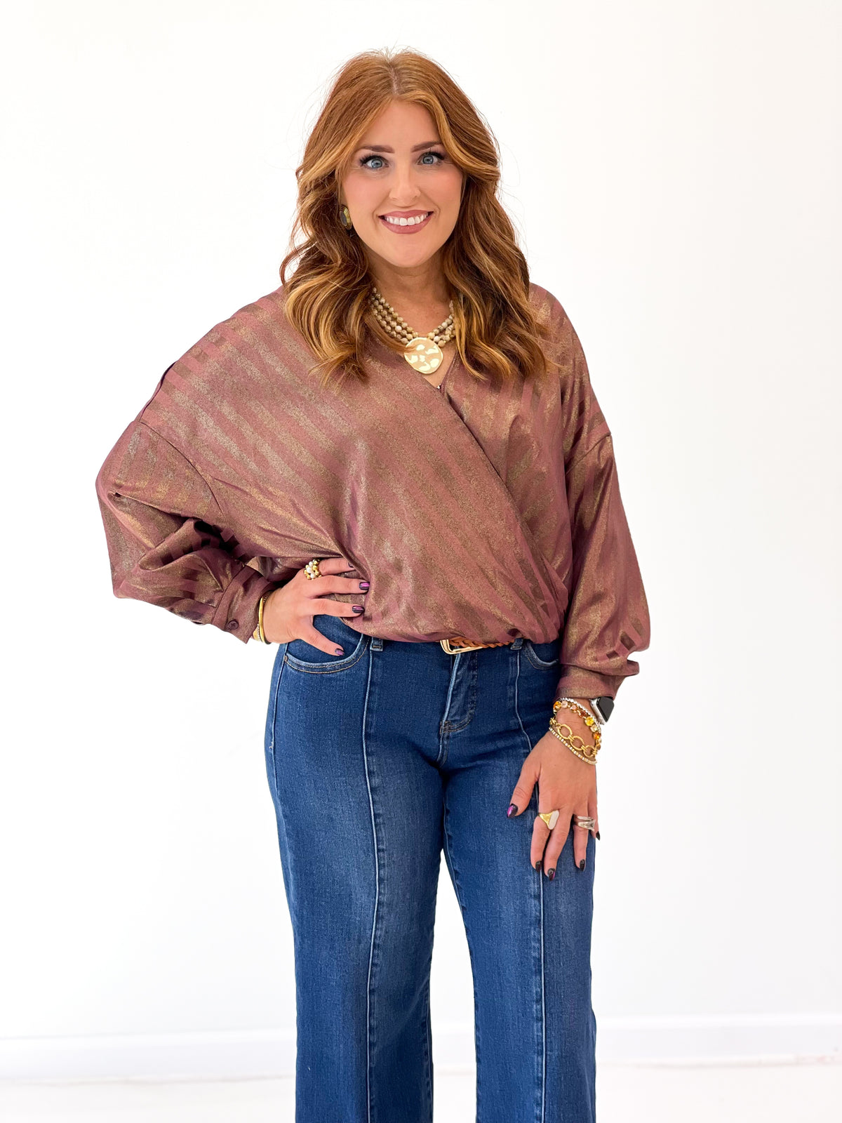 Burgundy metallic stripe wrap blouse detail with V-neck, long sleeves and gathered waist