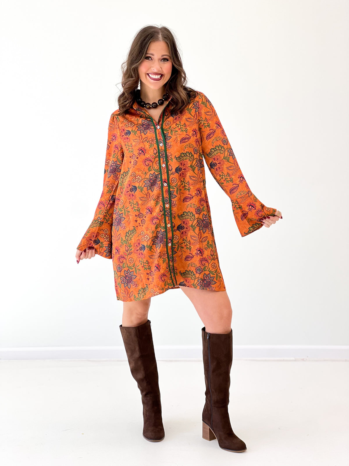 Orange floral button dress with bell sleeves and dark piping, knee-length