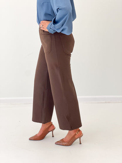 Brown straight-leg trousers with button front and front pockets, cropped straight silhouette
