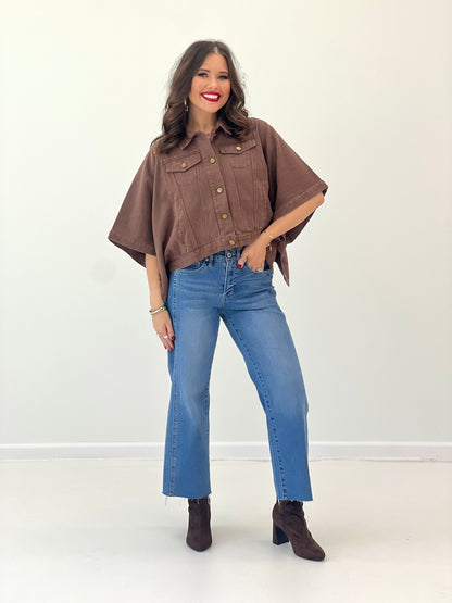 Brown short-sleeve snap-button denim jacket with chest flap pockets and brass-tone buttons