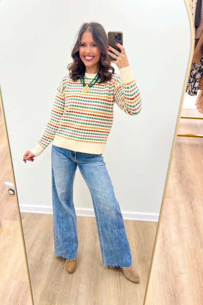 Multi-color striped sweater with cream ribbed cuffs and hem, crew neck, relaxed fit