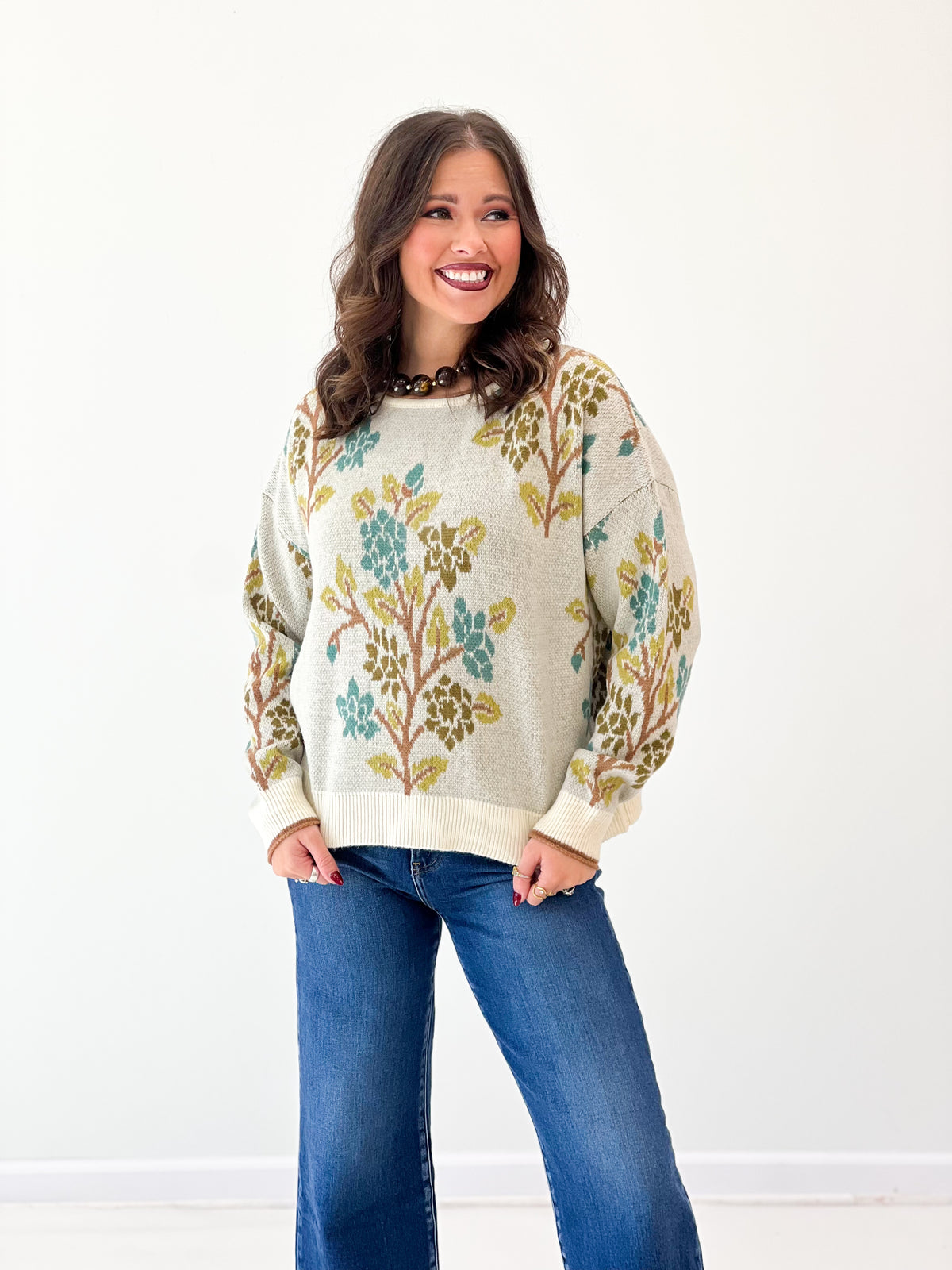 Cream knit sweater top with tree graphic print, crew neck, long sleeves, ribbed cuffs