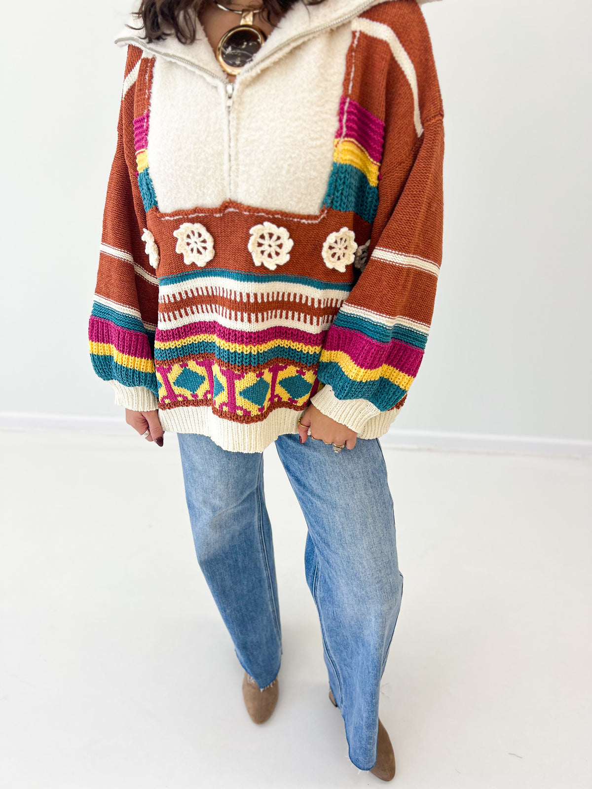 Close-up of brick multi half-zip hooded sweater front with striped yoke knit design