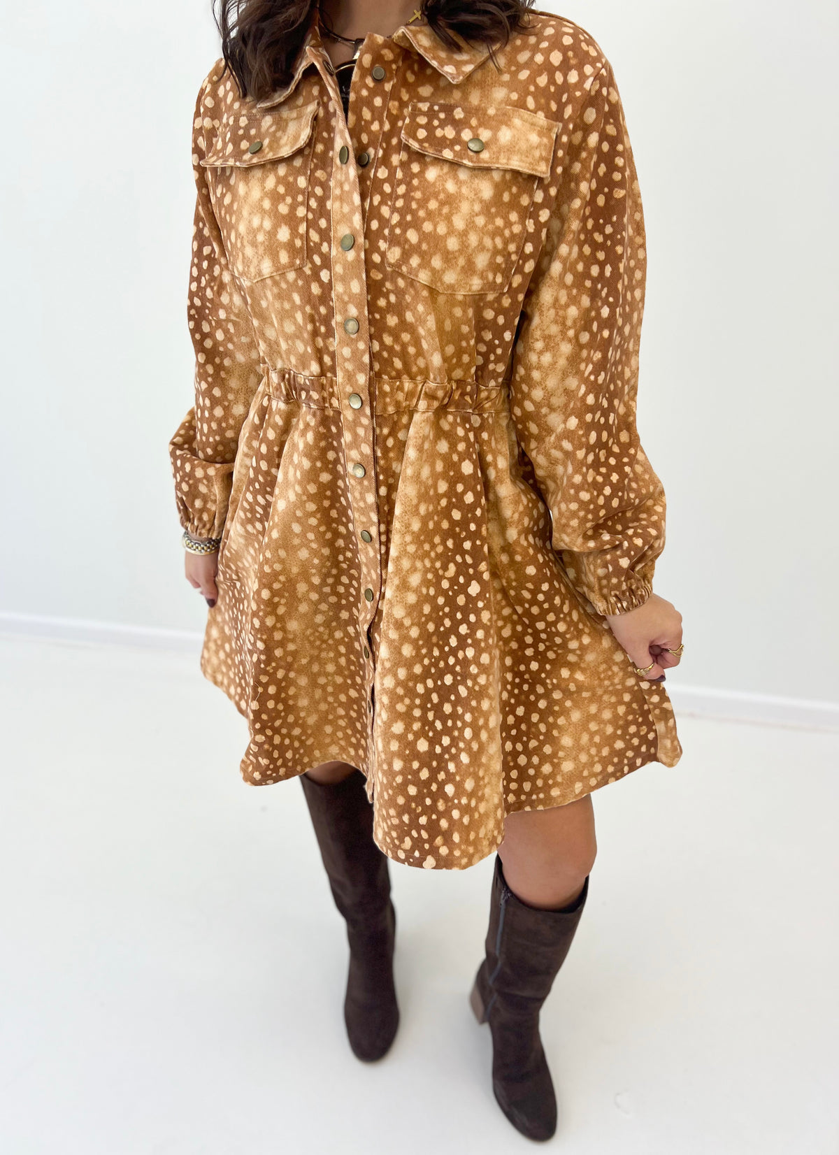Close-up of bambi print button-down mini dress with collar and button placket, brown