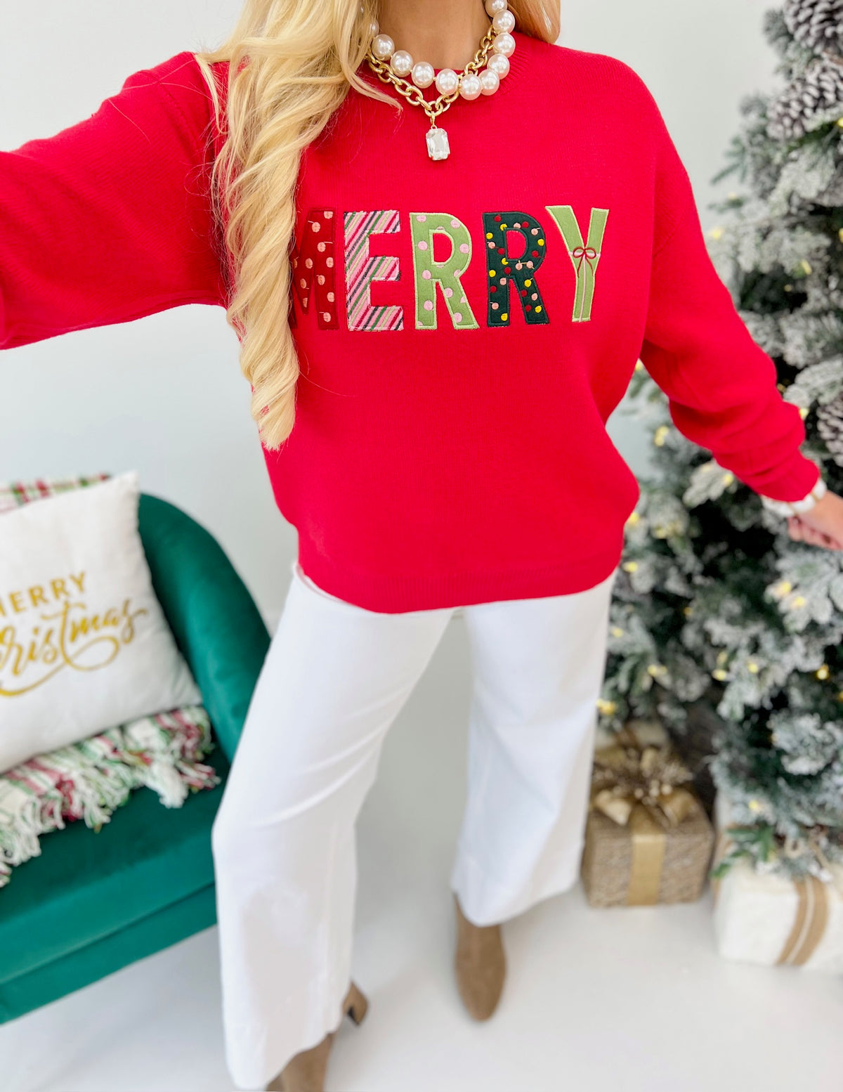 Red crewneck Christmas sweater with bold colorful “MERRY” letter graphic