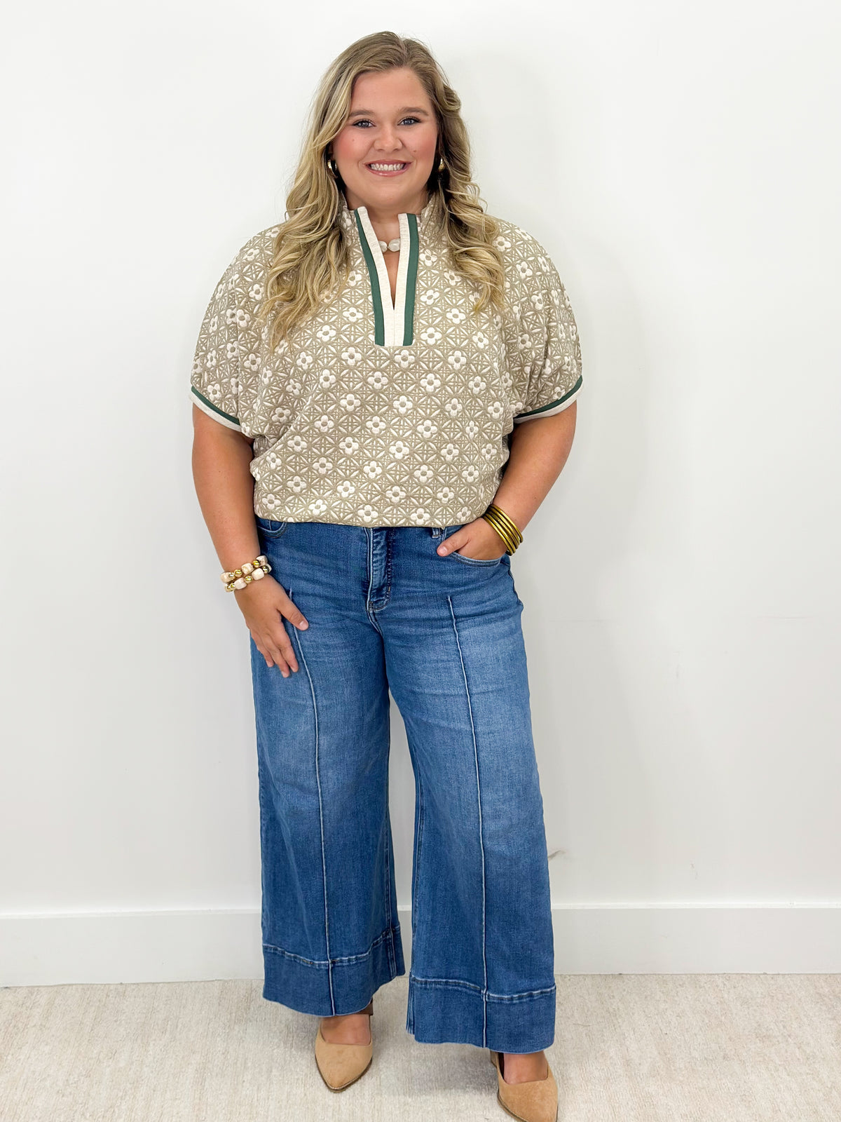 Taupe jacquard pullover top with white and green contrast trim at neckline