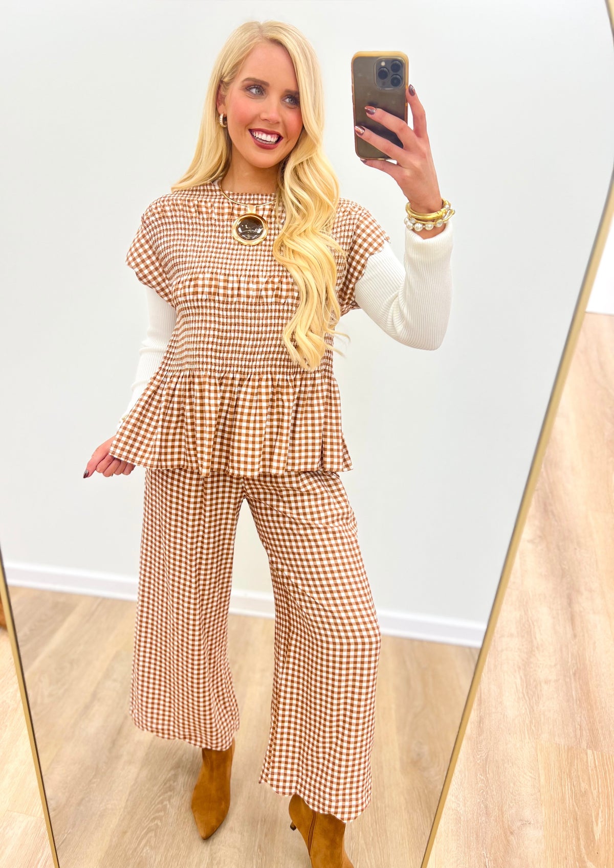 Red-and-white check smocked peplum top with scalloped sleeves and circular neckline embellishment