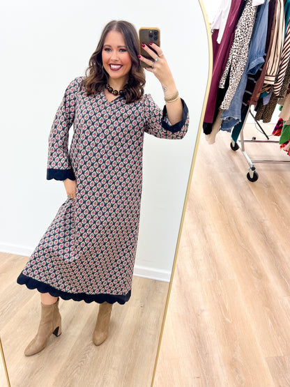 Navy floral V-neck maxi dress, side view, with long sleeves and scalloped hem