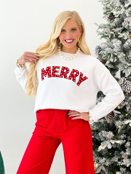 Off-white sweater with bold red 'MERRY' lettering and red detachable knit scarf at neckline