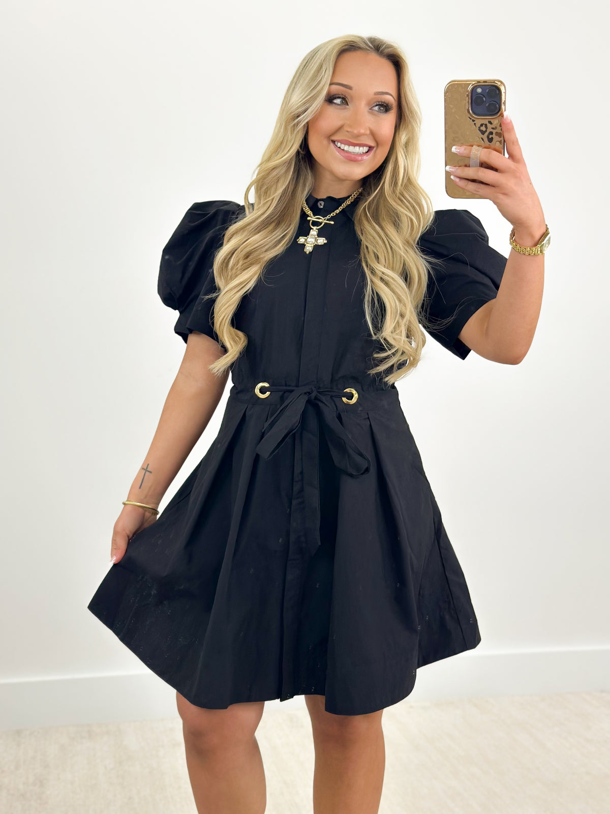 Black puff-sleeve pleated mini dress with tie waist and gathered skirt