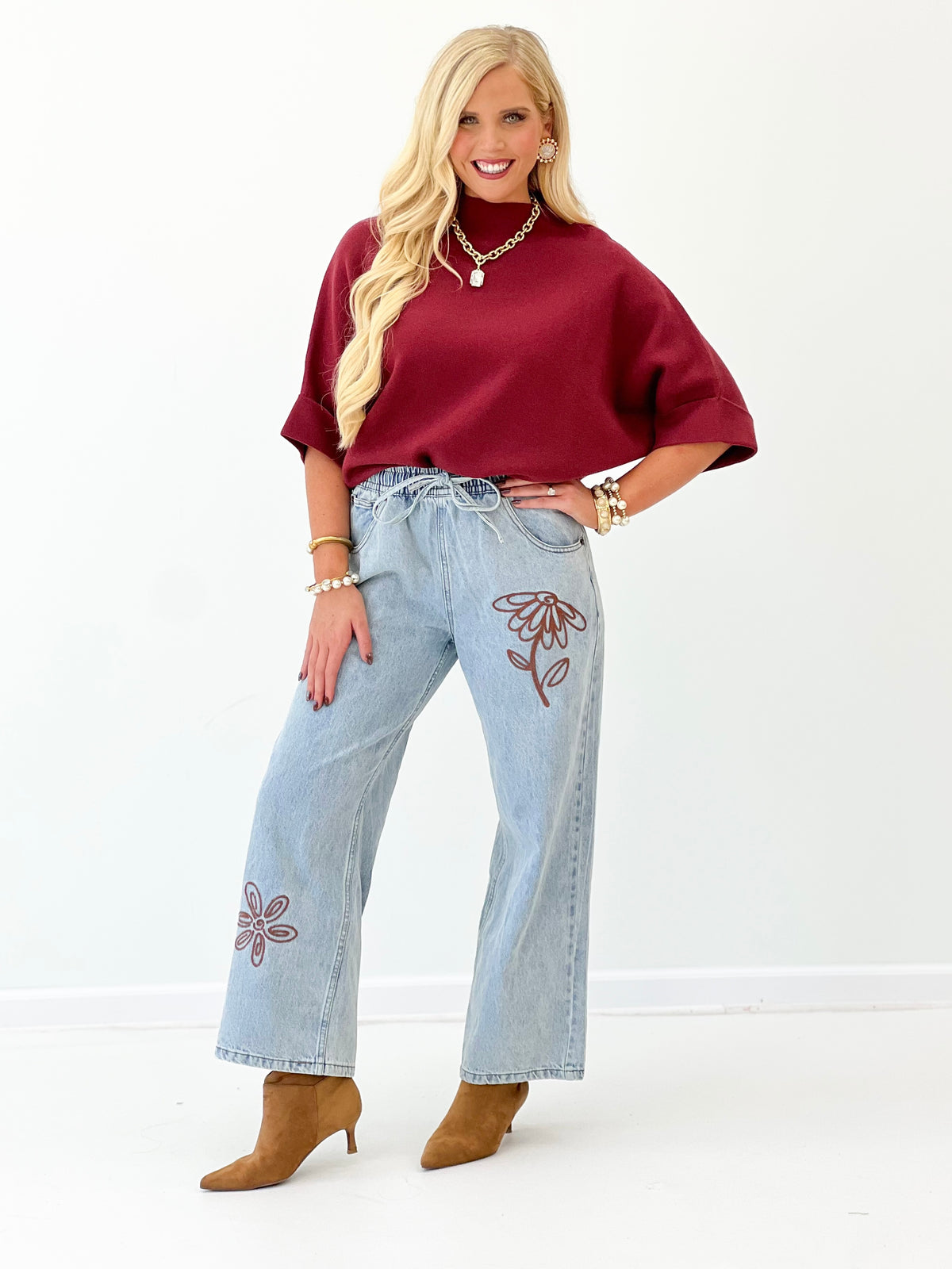 Burgundy mock-neck pullover sweater with loose drape and short sleeves