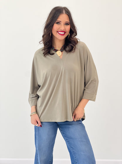 V-neck quarter-sleeve top in khaki with loose silhouette and smooth fabric