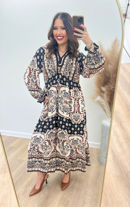 Abstract print midi dress with contrast trim, V-neck, and long sleeves