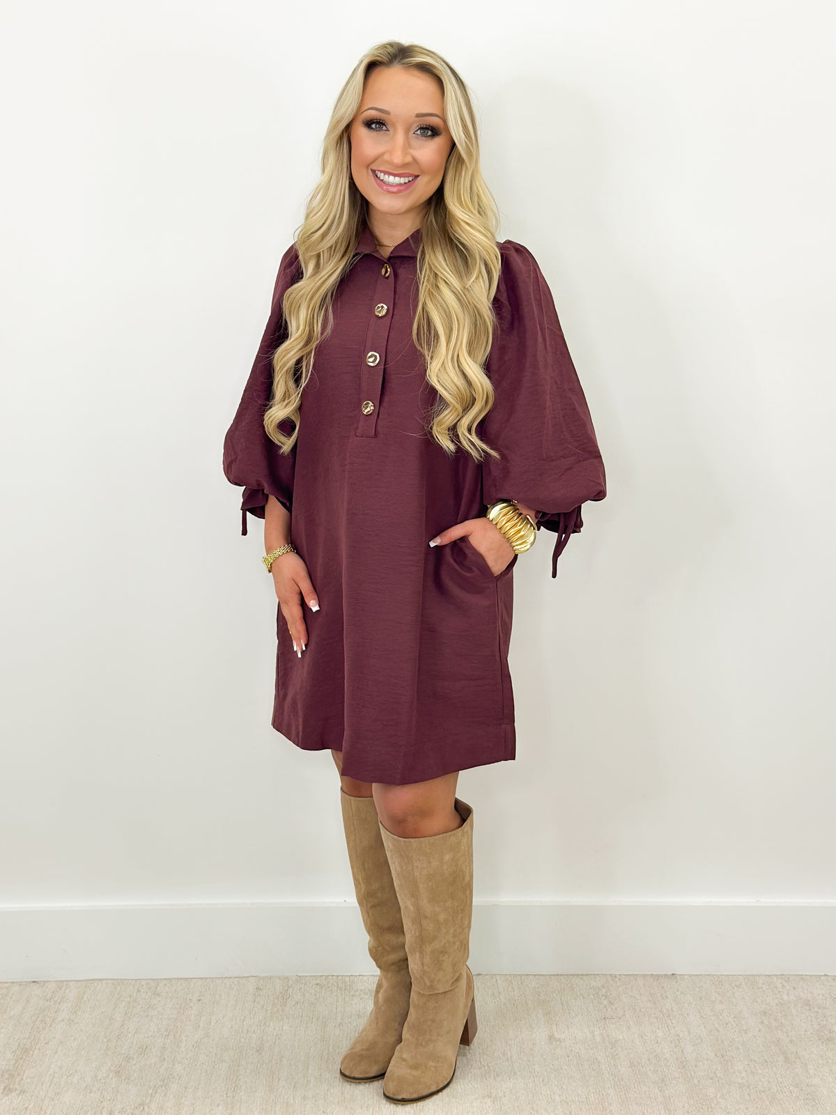 Merlot balloon-sleeve stand-collar mini dress with button front, worn with tall boots