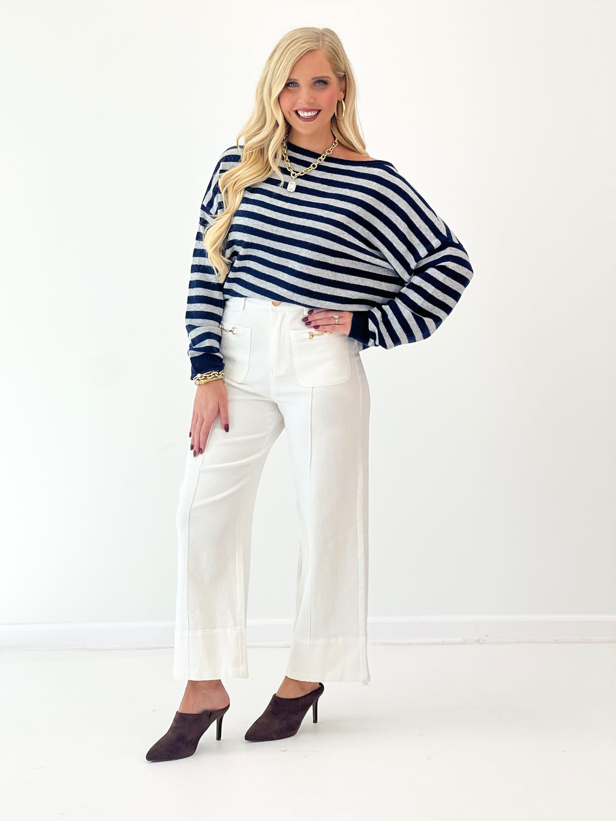 Navy and white striped off-shoulder sweater with long sleeves and ribbed cuffs