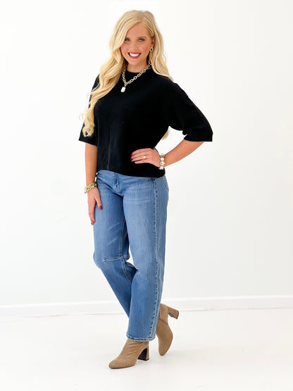 Heathered black crew neck sweater with short sleeves and clean neckline