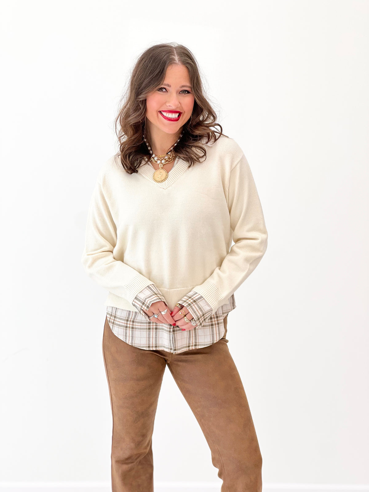 Cream V-neck pullover with plaid collared layer at hem, long sleeves