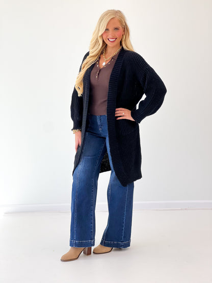 Black oversized loose-knit duster cardigan with long sleeves and open front