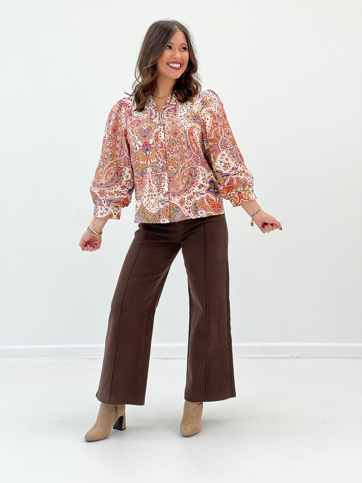 Cream floral ruffle-neck button-down top with long puff sleeves and button placket