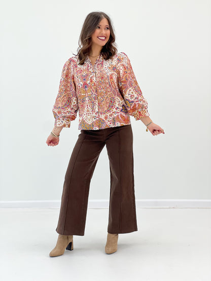 Cream floral ruffle-neck button-down top with long puff sleeves and button placket