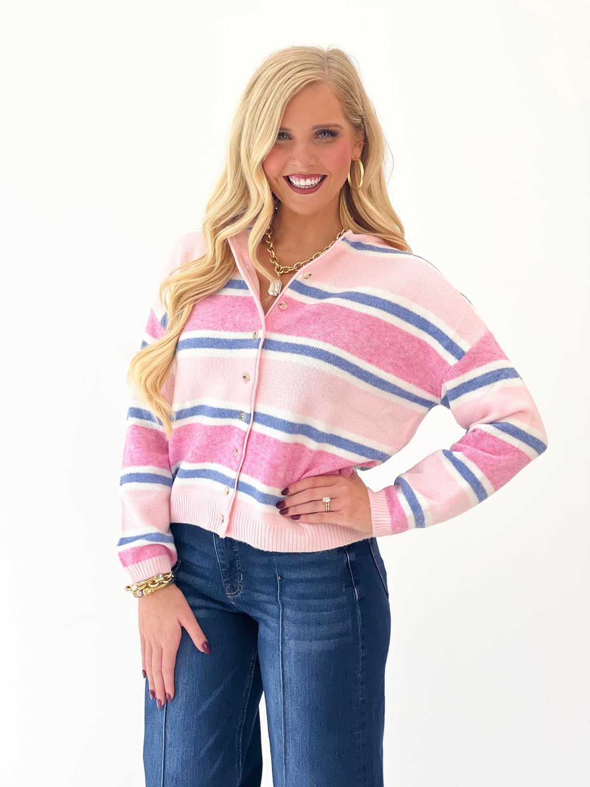 Pink multi-striped long sleeve cardigan with button front, soft knit, ribbed cuffs.