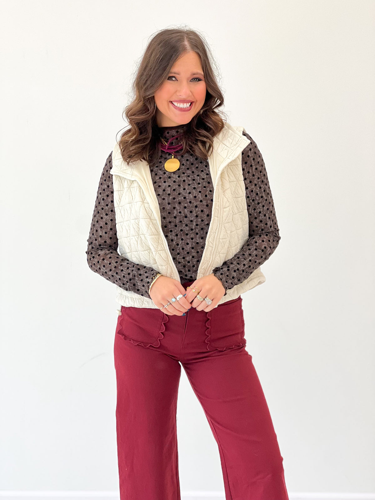 Ivory diamond-quilted sleeveless vest with collared neckline and open front