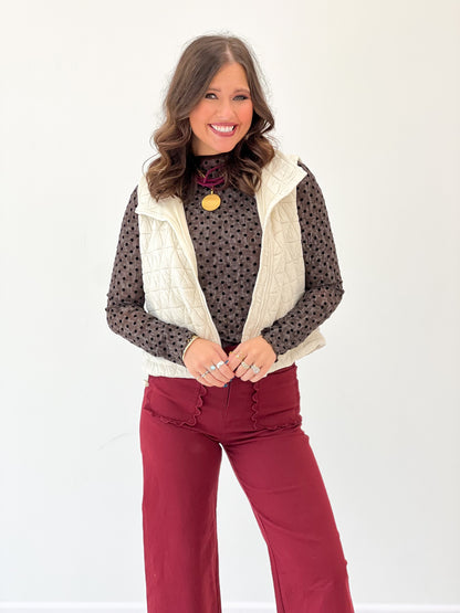 Ivory diamond-quilted sleeveless vest with collared neckline and open front