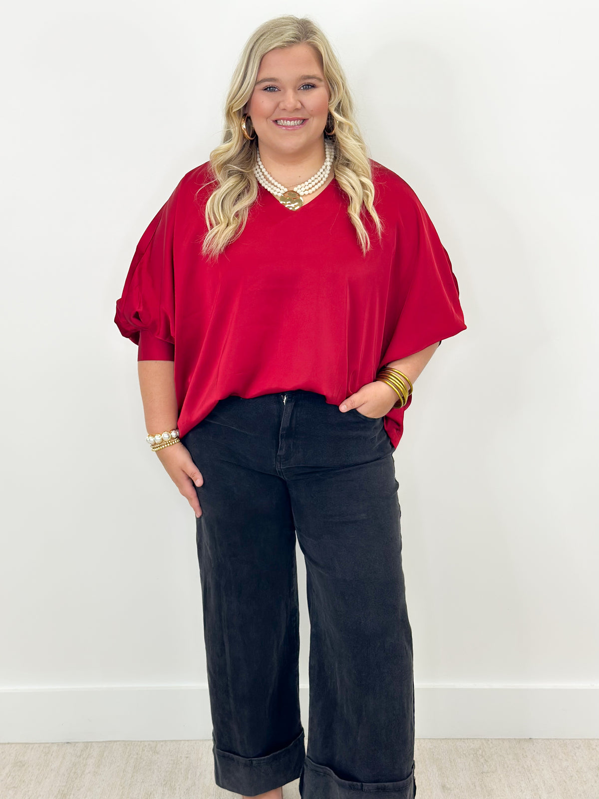 Ruby v-neck oversized top with cuffed sleeves, loose drape over jeans
