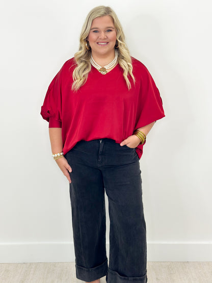 Ruby v-neck oversized top with cuffed sleeves, loose drape over jeans