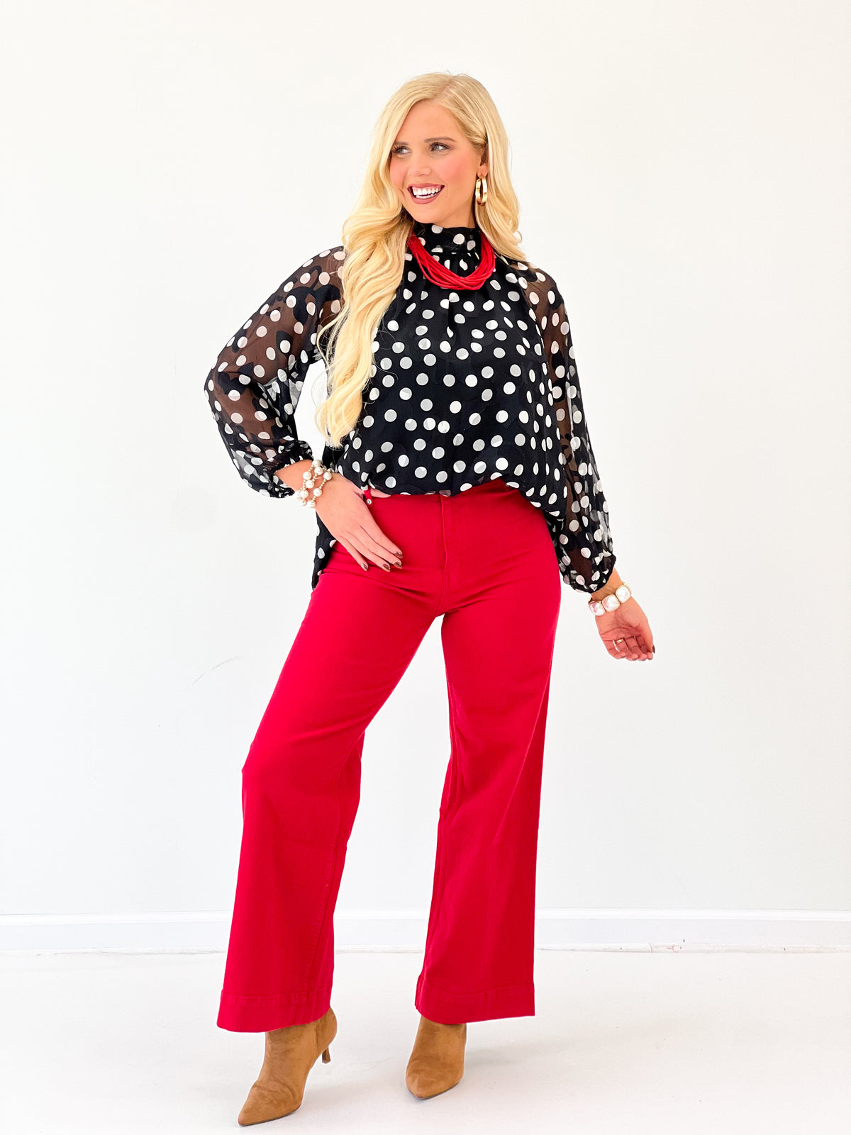 Black polka dot high-neck long-sleeve blouse with red contrast collar