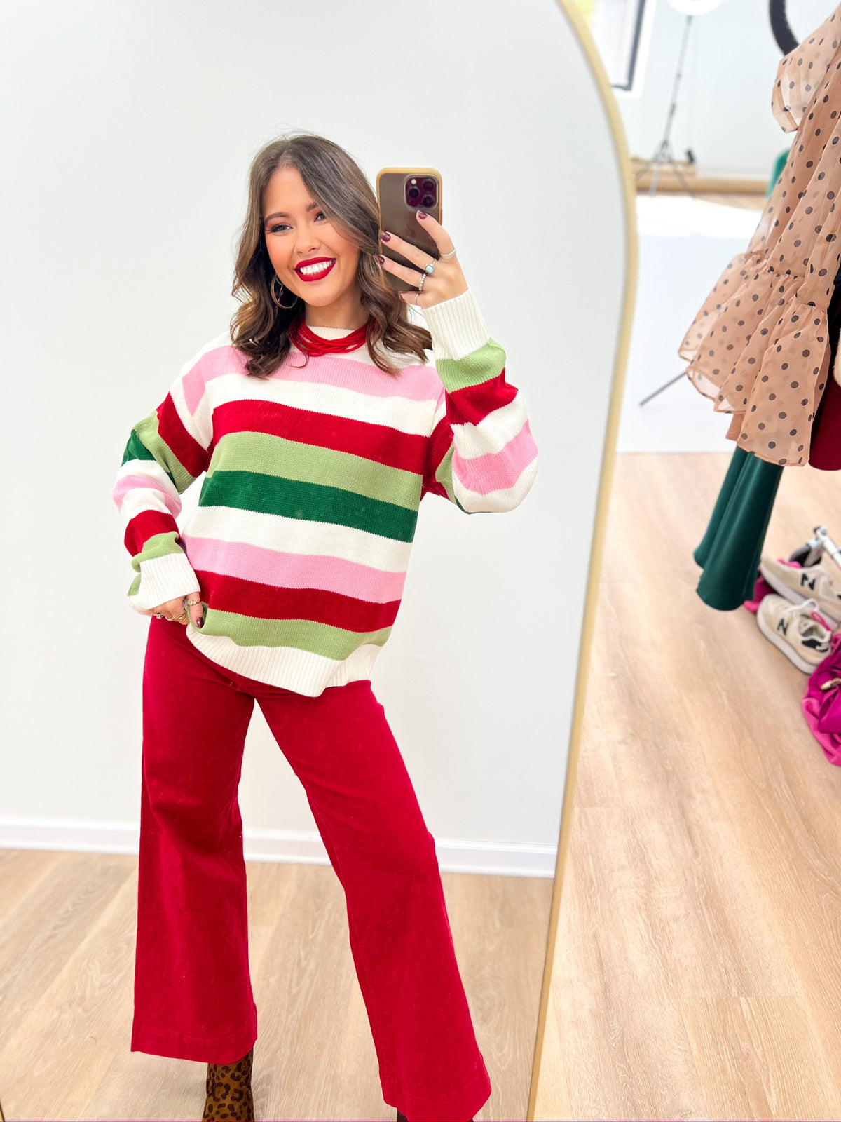 Multicolor striped knit sweater with crew neck and long sleeves in pink, green, and red stripes