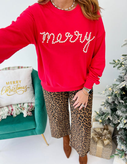 Red crewneck sweatshirt with pearl 'merry' lettering on the front.