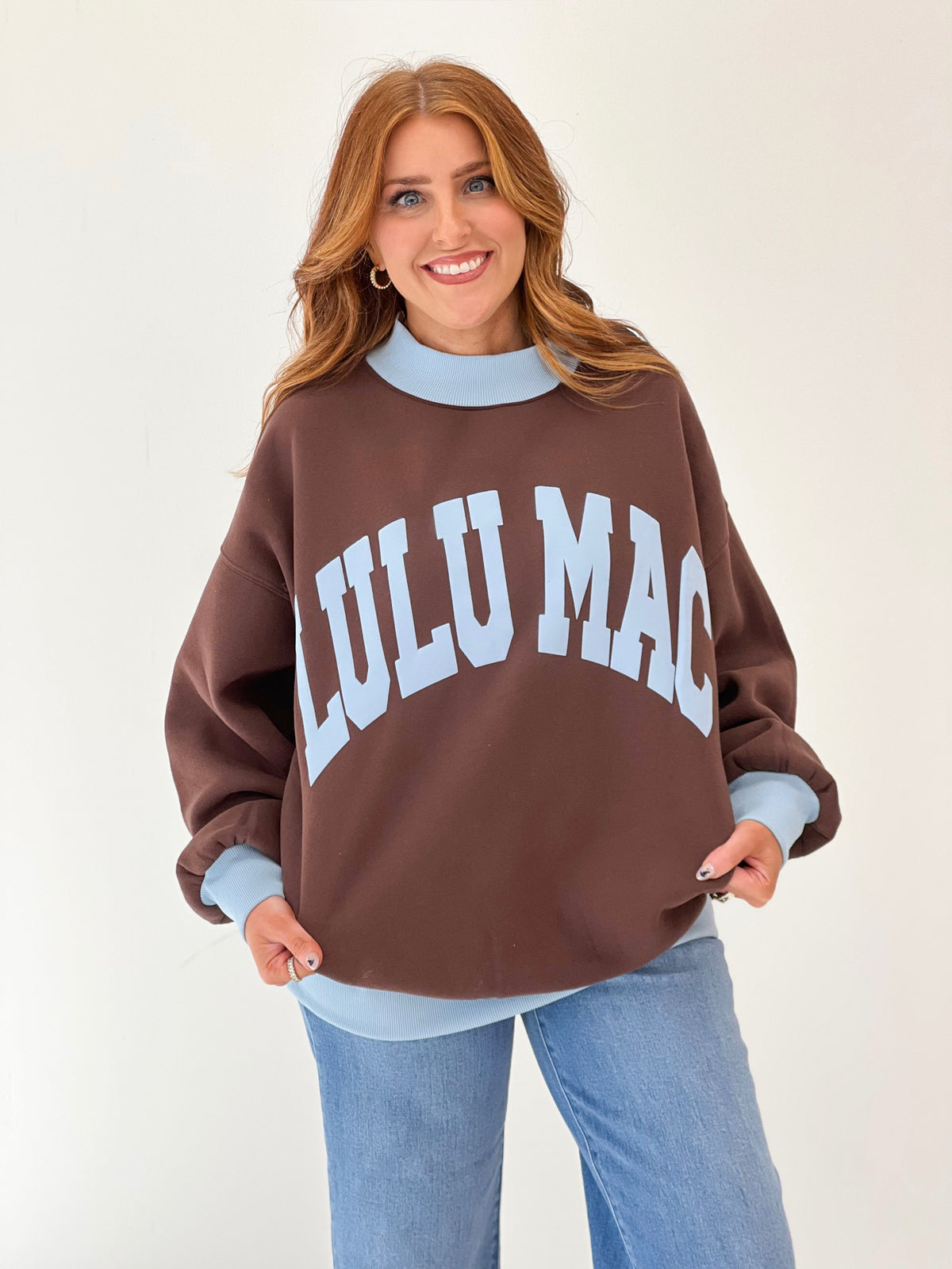 LuLu Mac brown puff mock neck sweatshirt with white “LULU MAC” lettering and light blue collar