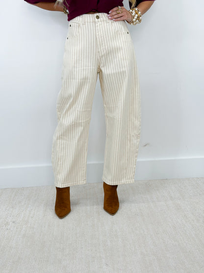 Cream pinstripe barrel pants with front button closure and side pockets