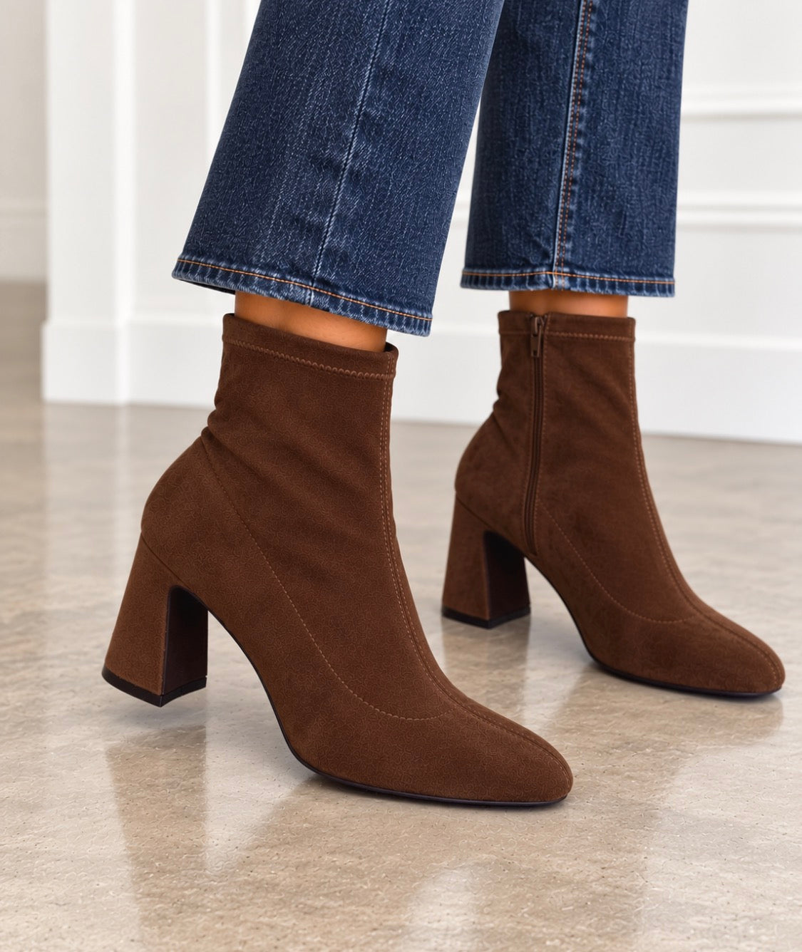 Front-facing chocolate suede ankle booties with block heel and pull-on shaft