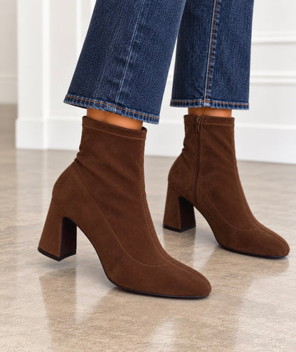 Front-facing chocolate suede ankle booties with block heel and pull-on shaft