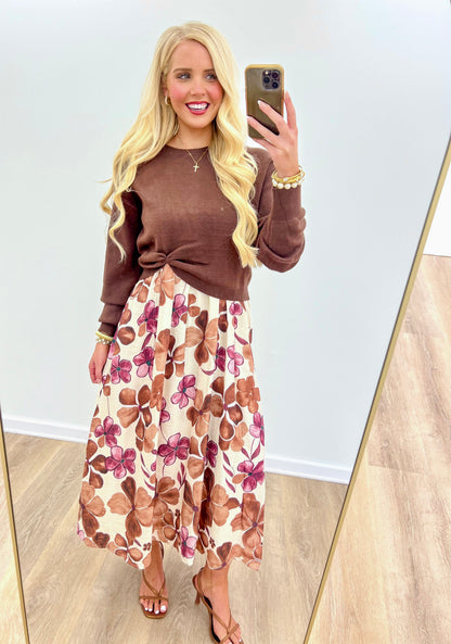 Sleeveless midi dress set with dark brown tie-front bodice and floral skirt, long tiered hem