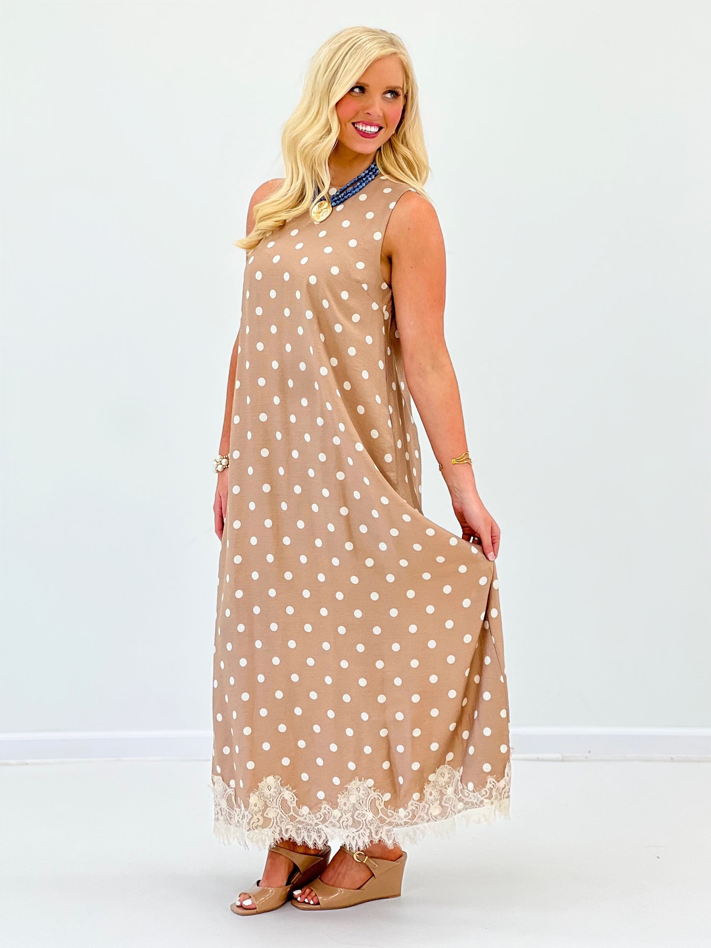 Latte polka dot sleeveless midi dress, side view with lace-trim hem and round neck